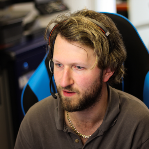 An it engineer sat at a desk with a headset on - providing managed it services, tavistock, plymouth, okehampton, exeter, devon and cornwall